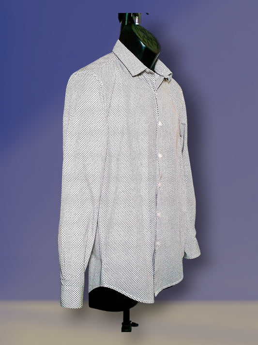 A long-sleeve button-up shirt with a small white and black micro-pattern, displayed on a black mannequin torso against a purple gradient background.