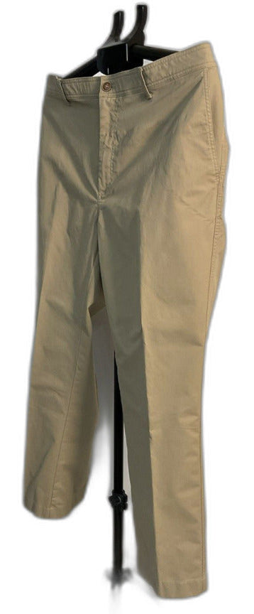 A pair of khaki-colored chino pants displayed on a black hanger stand against a plain white background.