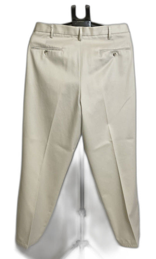 A pair of light beige chino pants hanging on a black hanger against a white background.