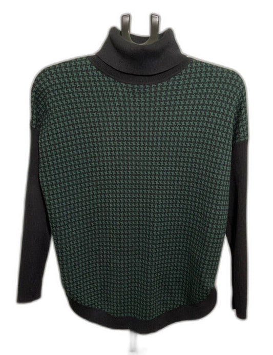 A dark green and black houndstooth turtleneck sweater with black trim, displayed on a mannequin torso against a white background.