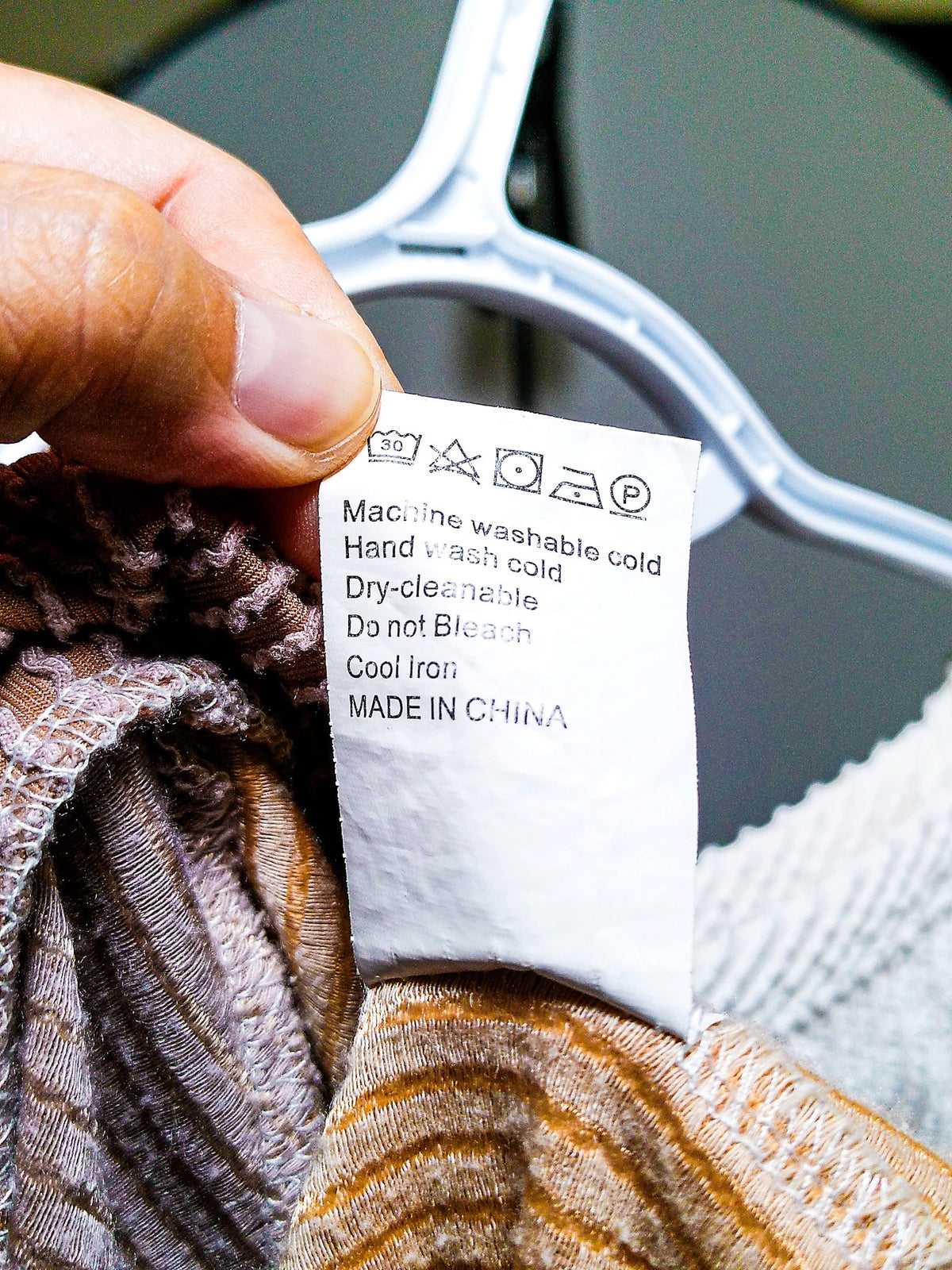 Care label showing machine wash cold instructions, made in China
