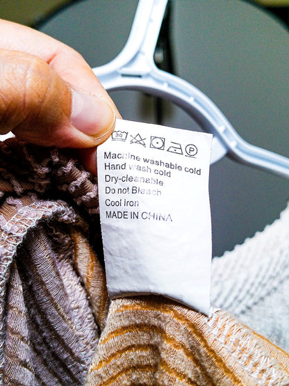 Care label showing machine wash cold instructions, made in China