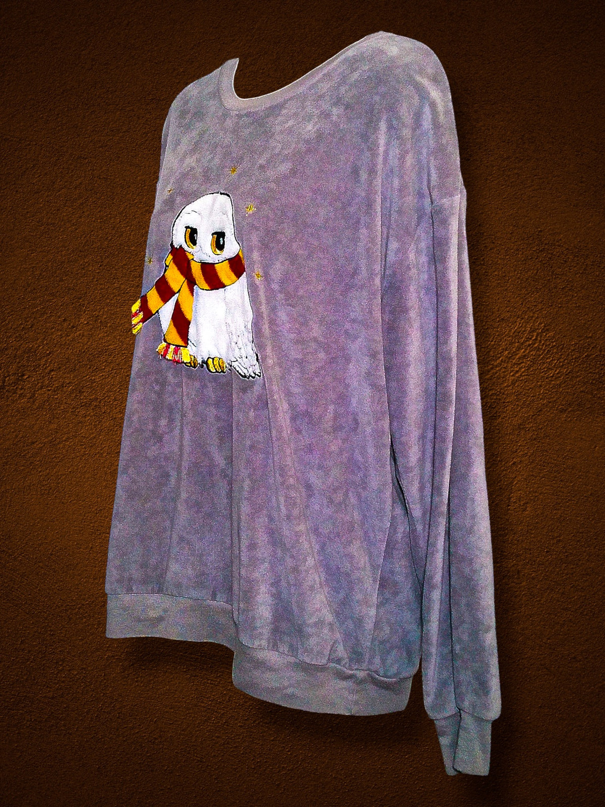 Left angled front and sleeve of Harry Potter Hedwig velour sleep top
