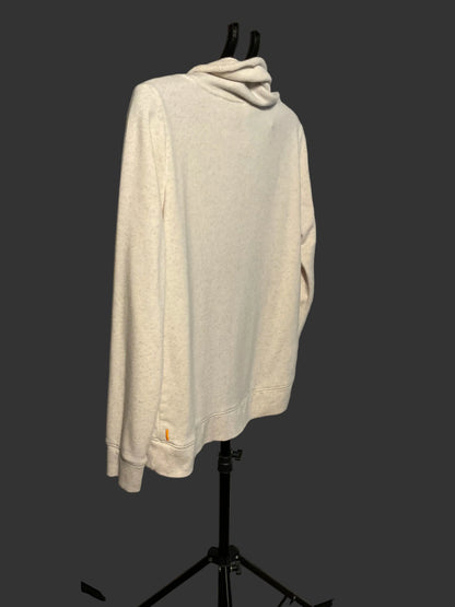 A cream-colored long-sleeve sweatshirt with a cowl neck, displayed on a black clothing stand against a gray studio backdrop.