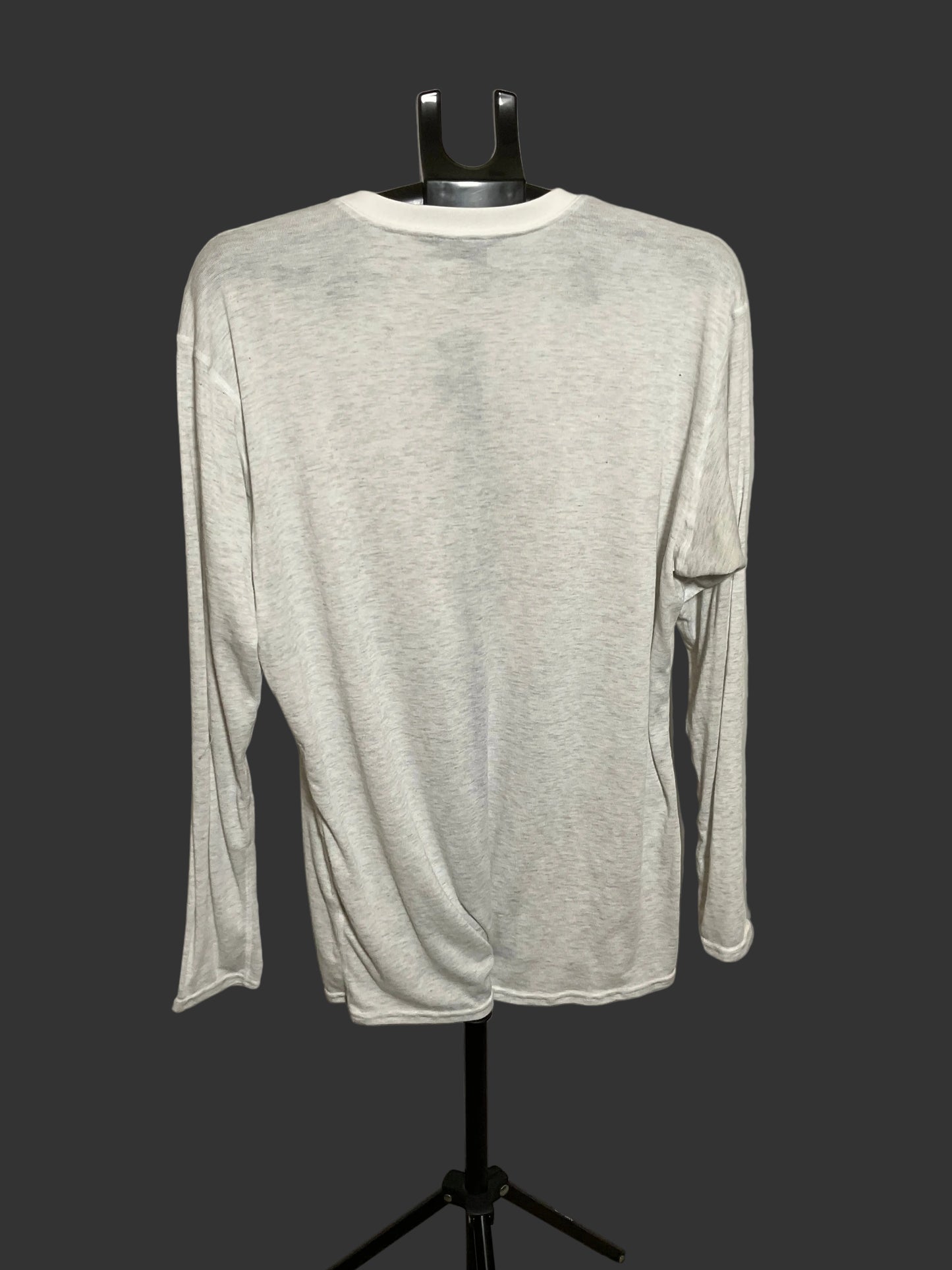 A light heather gray long-sleeve shirt displayed on a black dress form mannequin against a dark gray background.