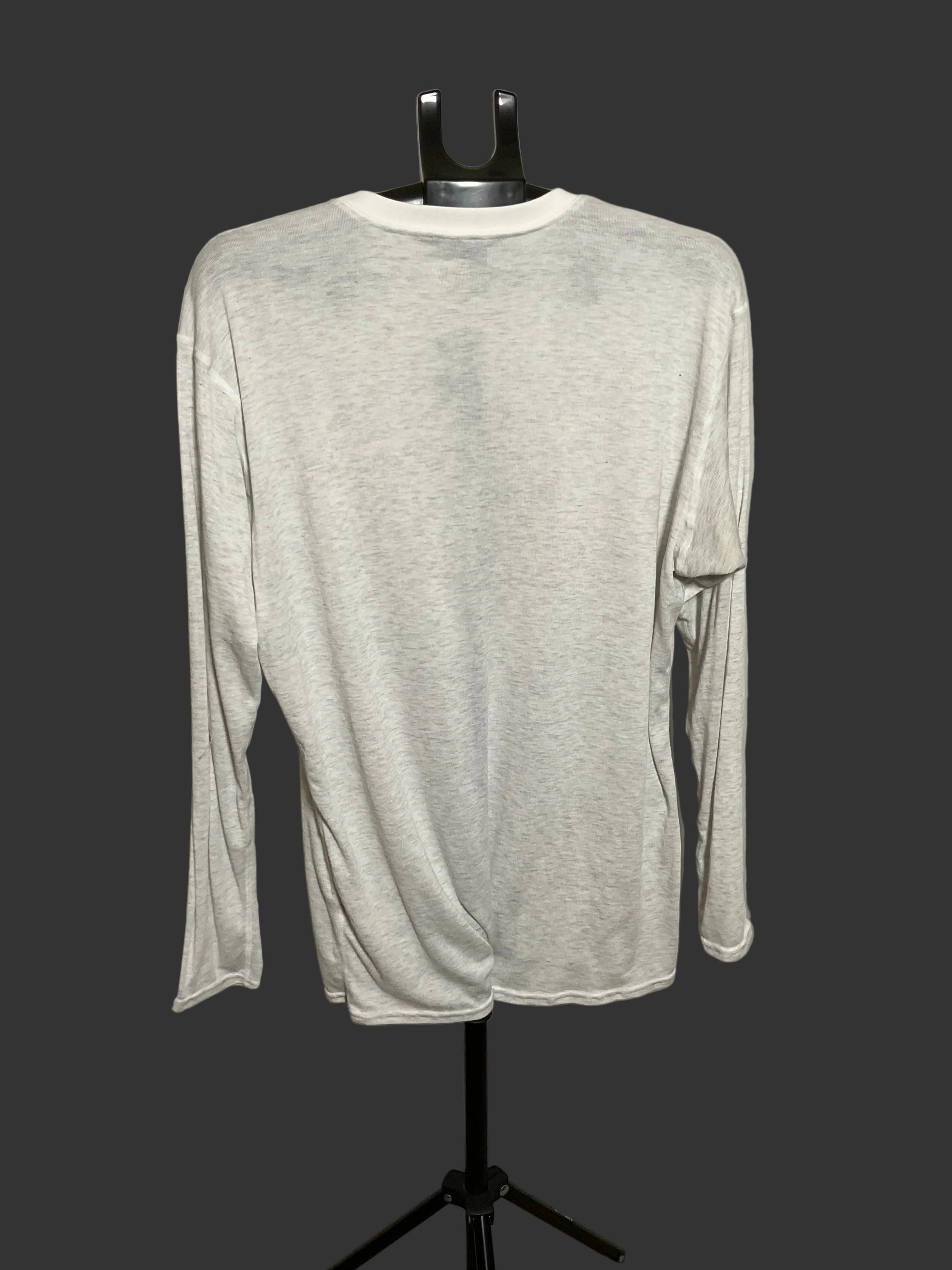 A light heather gray long-sleeve shirt displayed on a black dress form mannequin against a dark gray background.