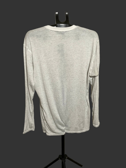 A light heather gray long-sleeve shirt displayed on a black dress form mannequin against a dark gray background.