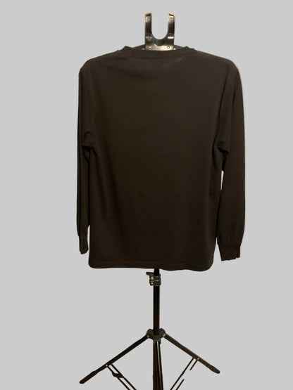 A dark brown long-sleeve crewneck shirt displayed on a black mannequin stand in front of a white circular studio backdrop.