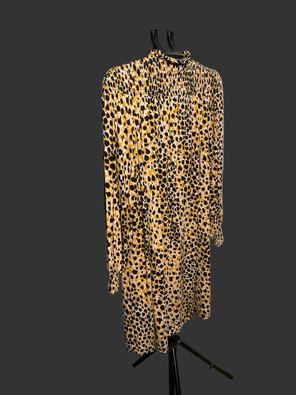 A long-sleeve high-neck dress with a yellow, black, and brown leopard print pattern, displayed on a black hanger stand in front of a white circular studio backdrop.