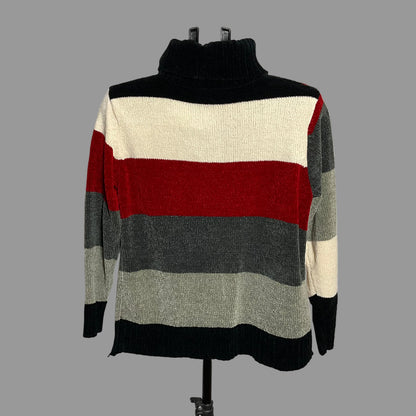 A striped knit turtleneck sweater displayed on a black dress form against a plain light gray wall. The sweater features horizontal stripes in black, cream, red, dark gray, and light gray.