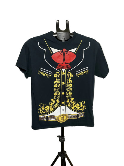 A black short-sleeve t-shirt displayed on a black hanger stand against a plain light gray wall. The shirt features a large graphic print of a military-style jacket with a red bow tie, gold embroidery, and white details.