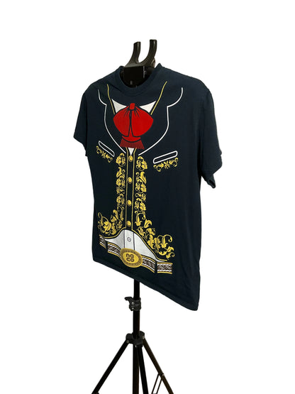 A navy blue short-sleeve t-shirt displayed on a black hanger stand in front of a white circular studio backdrop. The shirt features a large graphic print of a military-style jacket with a red bow tie, gold buttons, and white trim.