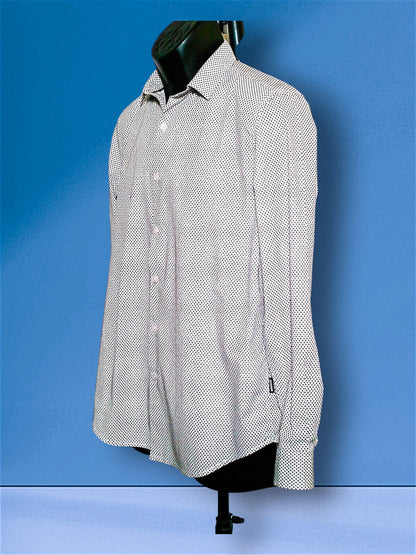 A long-sleeve button-up dress shirt with a small black-on-white micro-dot pattern, displayed on a black mannequin torso against a blue studio background.
