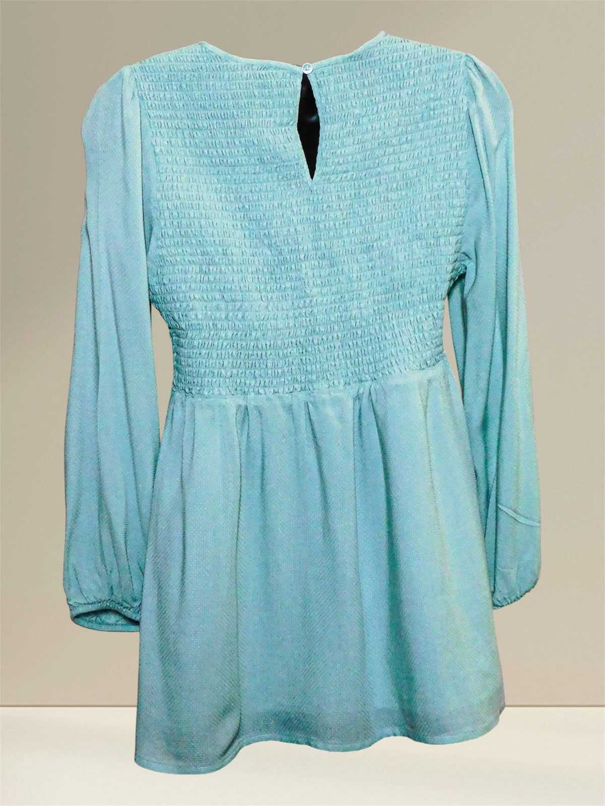 Back view showing smocking and button keyhole closure of the blue maternity top