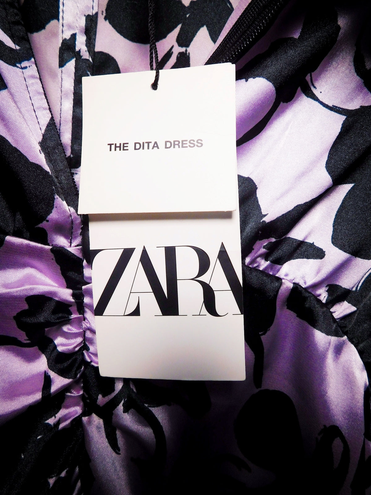 Zara hang tag identifying The Dita Dress