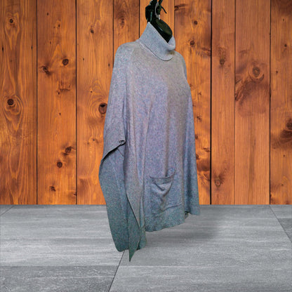 Side view showing draped poncho silhouette