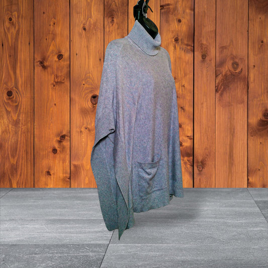 Side view showing draped poncho silhouette