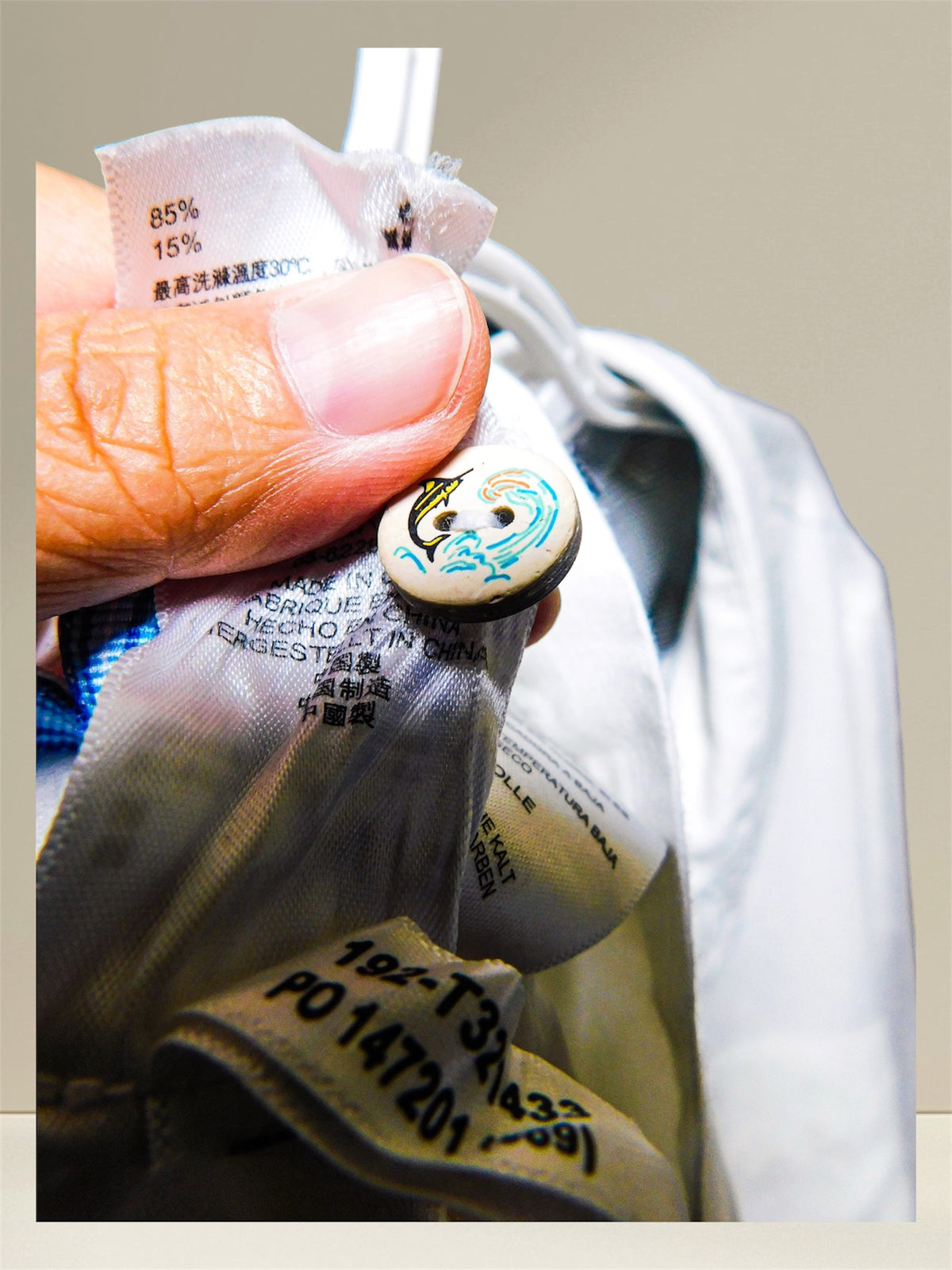 Close-up of decorative marlin and wave button detail